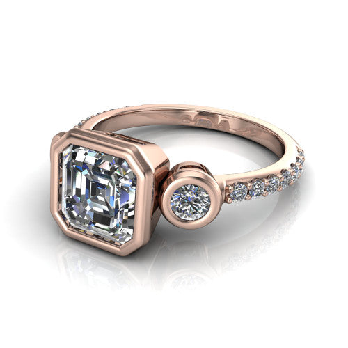 Chloe asscher three stone engagement ring in 18K Rose Gold, three-quarter perspective showing the bezel-set center between two bezel-set round side stones above a pav&eacute; shank