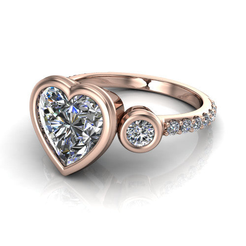 Chloe heart three stone engagement ring in 18K Rose Gold, three-quarter perspective showing the bezel-set center between two bezel-set round side stones above a pav&eacute; shank
