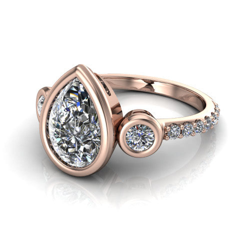 Chloe pear three stone engagement ring in 14K Rose Gold, three-quarter perspective showing the bezel-set center between two bezel-set round side stones above a pav&eacute; shank