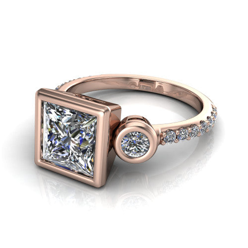 Chloe princess three stone engagement ring in 14K Rose Gold, three-quarter perspective showing the bezel-set center between two bezel-set round side stones above a pav&eacute; shank