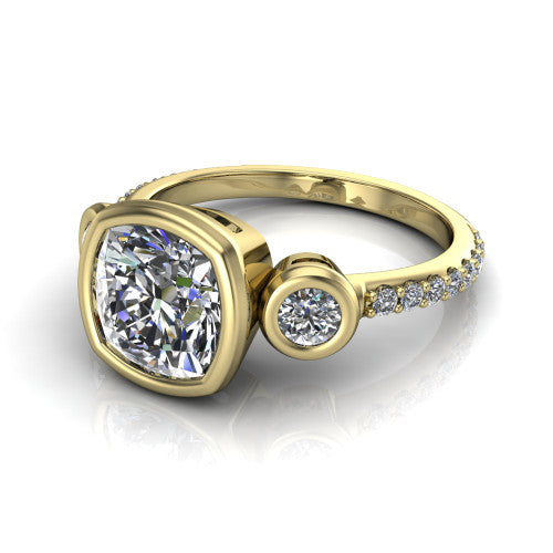 Chloe cushion three stone engagement ring in 18K Yellow Gold, three-quarter perspective showing the bezel-set center between two bezel-set round side stones above a pav&eacute; shank