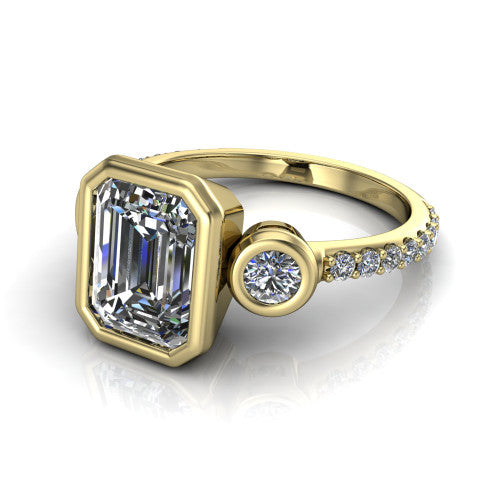 Chloe emerald three stone engagement ring in 14K Yellow Gold, three-quarter perspective showing the bezel-set center between two bezel-set round side stones above a pav&eacute; shank