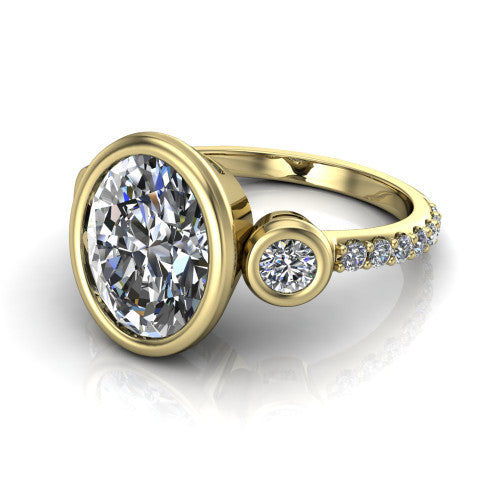Chloe oval three stone engagement ring in 14K Yellow Gold, three-quarter perspective showing the bezel-set center between two bezel-set round side stones above a pav&eacute; shank