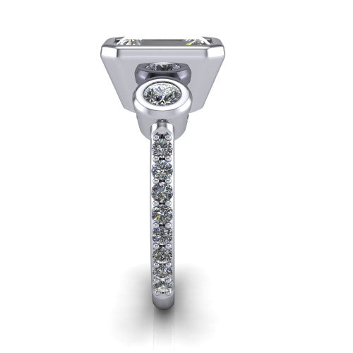 Chloe emerald three stone engagement ring in 18K White Gold, side profile showing the round bezel side stone and the pav&eacute; diamonds running down the shank