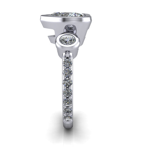 Chloe heart three stone engagement ring in 18K White Gold, side profile showing the round bezel side stone and the pav&eacute; diamonds running down the shank