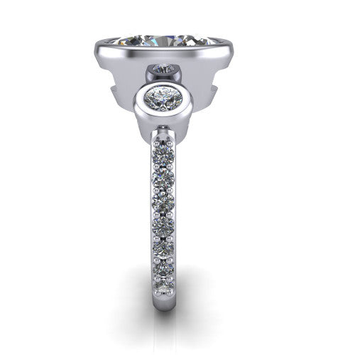Chloe oval three stone engagement ring in 18K White Gold, side profile showing the round bezel side stone and the pav&eacute; diamonds running down the shank