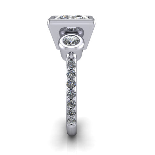 Chloe princess three stone engagement ring in 14K White Gold, side profile showing the round bezel side stone and the pav&eacute; diamonds running down the shank