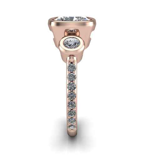 Chloe cushion three stone engagement ring in 14K Rose Gold, side profile showing the round bezel side stone and the pav&eacute; diamonds running down the shank