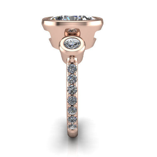 Chloe oval three stone engagement ring in 14K Rose Gold, side profile showing the round bezel side stone and the pav&eacute; diamonds running down the shank