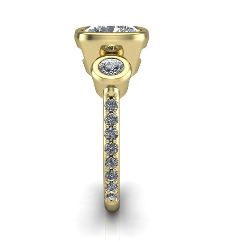 Chloe cushion three stone engagement ring in 18K Yellow Gold, side profile showing the round bezel side stone and the pav&eacute; diamonds running down the shank