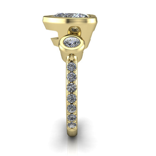 Chloe heart three stone engagement ring in 18K Yellow Gold, side profile showing the round bezel side stone and the pav&eacute; diamonds running down the shank