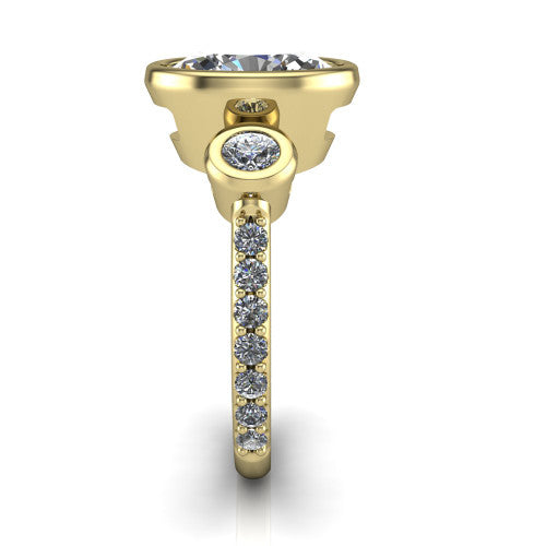 Chloe oval three stone engagement ring in 18K Yellow Gold, side profile showing the round bezel side stone and the pav&eacute; diamonds running down the shank