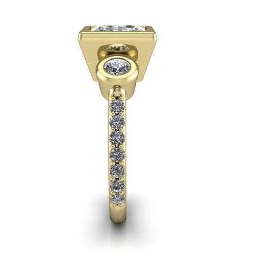Chloe princess three stone engagement ring in 18K Yellow Gold, side profile showing the round bezel side stone and the pav&eacute; diamonds running down the shank