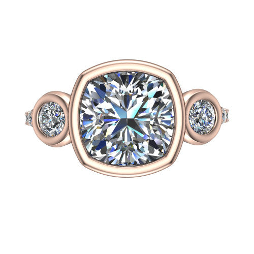 Chloe cushion three stone engagement ring in 18K Rose Gold, top-down view showing the bezel-set center flanked by two round side stones in bezels over a pav&eacute; band