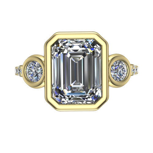 Chloe emerald three stone engagement ring in 18K Yellow Gold, top-down view showing the bezel-set center flanked by two round side stones in bezels over a pav&eacute; band