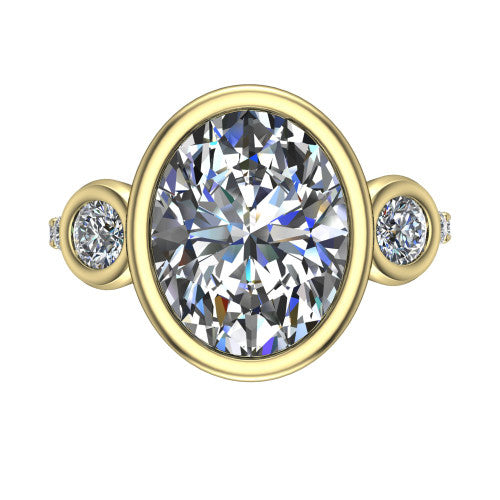 Chloe oval three stone engagement ring in 14K Yellow Gold, top-down view showing the bezel-set center flanked by two round side stones in bezels over a pav&eacute; band