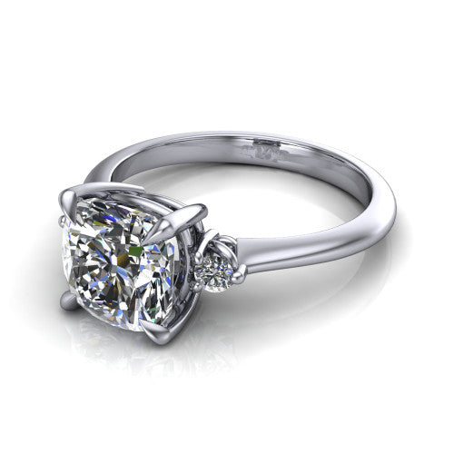 Olive cushion three stone engagement ring in 14K White Gold, three-quarter perspective showing the center diamond between two round side stones on a slim polished band