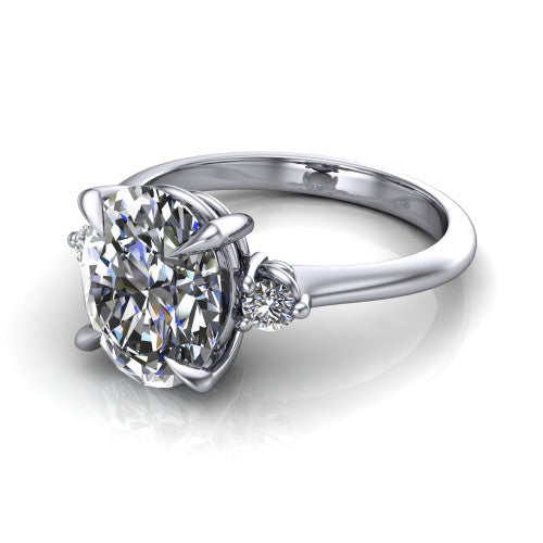 Olive oval three stone engagement ring in 18K White Gold, three-quarter perspective showing the center diamond between two round side stones on a slim polished band
