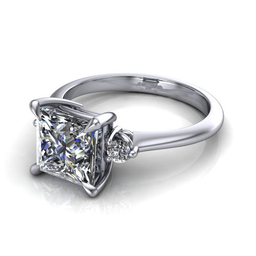 Olive princess three stone engagement ring in 18K White Gold, three-quarter perspective showing the center diamond between two round side stones on a slim polished band