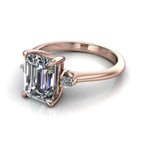 Olive emerald three stone engagement ring in 14K Rose Gold, three-quarter perspective showing the center diamond between two round side stones on a slim polished band
