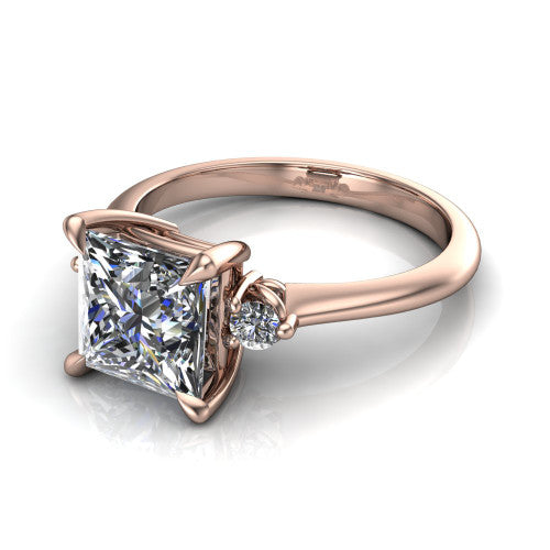 Olive princess three stone engagement ring in 14K Rose Gold, three-quarter perspective showing the center diamond between two round side stones on a slim polished band