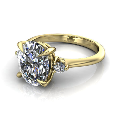 Olive oval three stone engagement ring in 18K Yellow Gold, three-quarter perspective showing the center diamond between two round side stones on a slim polished band