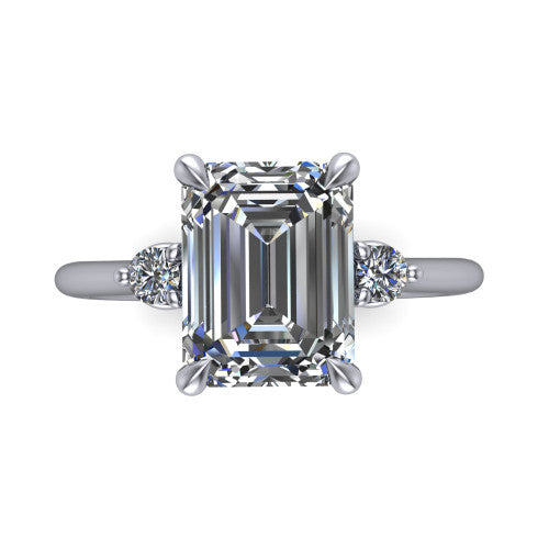 Olive emerald three stone engagement ring in Platinum, top-down view showing the center diamond flanked by two round side stones in a classic three stone setting
