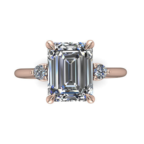 Olive emerald three stone engagement ring in 18K Rose Gold, top-down view showing the center diamond flanked by two round side stones in a classic three stone setting