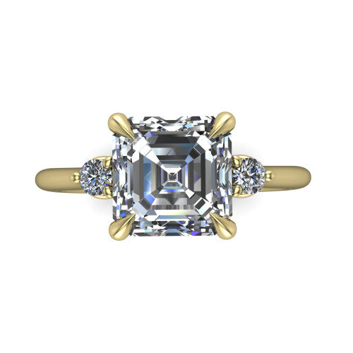 Olive asscher three stone engagement ring in 18K Yellow Gold, top-down view showing the center diamond flanked by two round side stones in a classic three stone setting