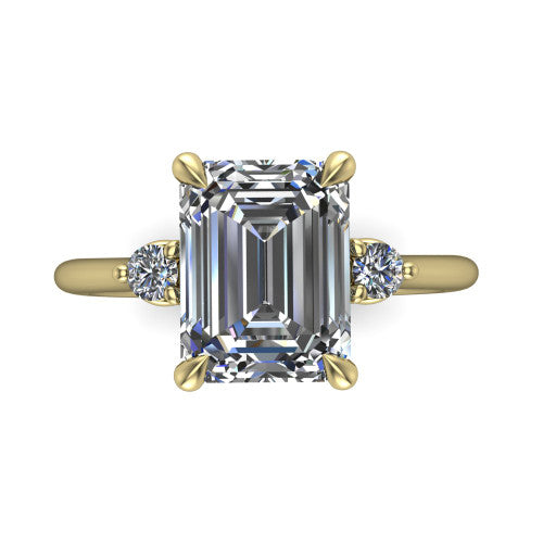 Olive emerald three stone engagement ring in 14K Yellow Gold, top-down view showing the center diamond flanked by two round side stones in a classic three stone setting