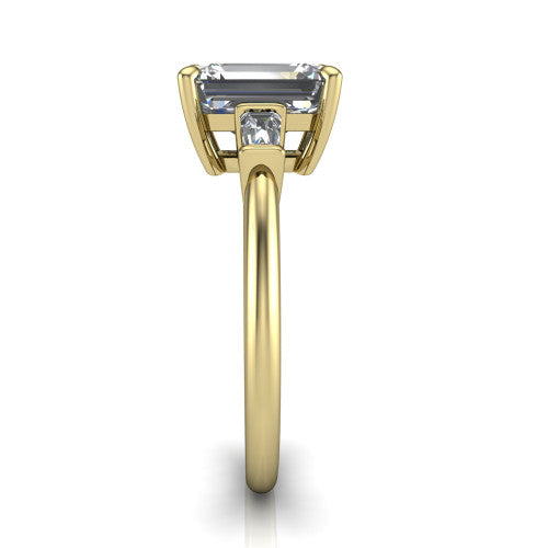 Jade emerald three stone engagement ring in 18K Yellow Gold with tapered baguette side stones, side profile showing the plain band and bar-set baguette