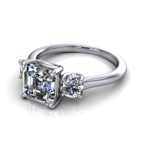 Emma asscher three stone engagement ring in 14K White Gold, three-quarter perspective showing the center diamond between two round side stones on a slim polished band