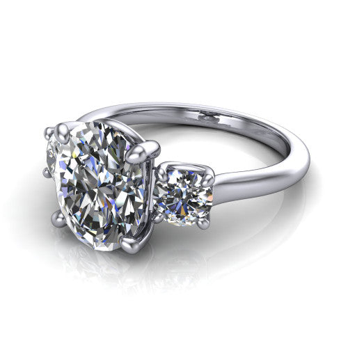 Emma oval three stone engagement ring in 18K White Gold, three-quarter perspective showing the center diamond between two round side stones on a slim polished band