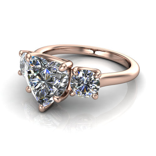 Emma heart three stone engagement ring in 14K Rose Gold, three-quarter perspective showing the center diamond between two round side stones on a slim polished band