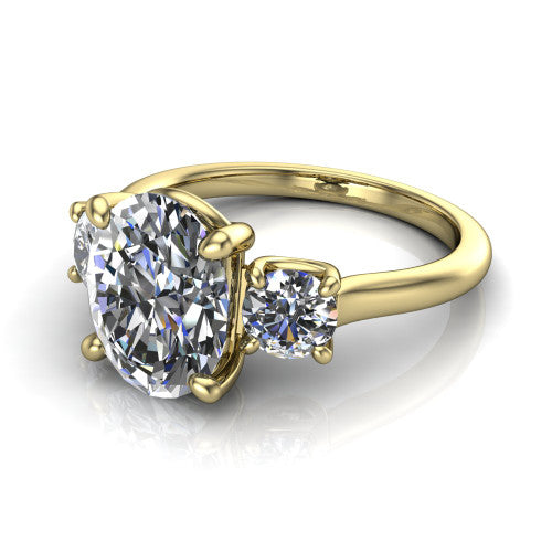 Emma oval three stone engagement ring in 14K Yellow Gold, three-quarter perspective showing the center diamond between two round side stones on a slim polished band