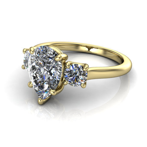Emma pear three stone engagement ring in 14K Yellow Gold, three-quarter perspective showing the center diamond between two round side stones on a slim polished band