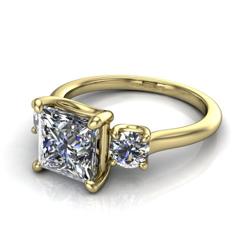 Emma princess three stone engagement ring in 14K Yellow Gold, three-quarter perspective showing the center diamond between two round side stones on a slim polished band