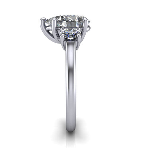 Emma pear three stone engagement ring in Platinum, side profile showing the round side stone and the smooth tapered polished band