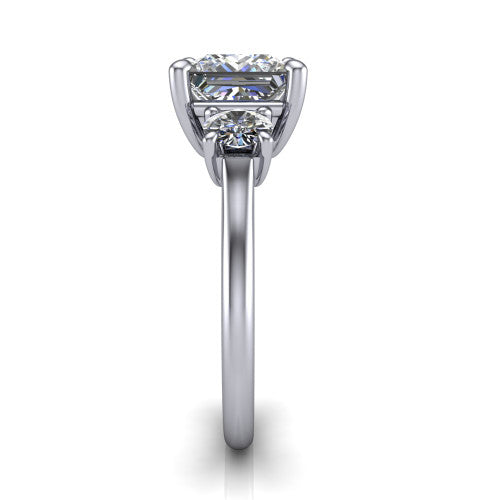 Emma princess three stone engagement ring in 18K White Gold, side profile showing the round side stone and the smooth tapered polished band