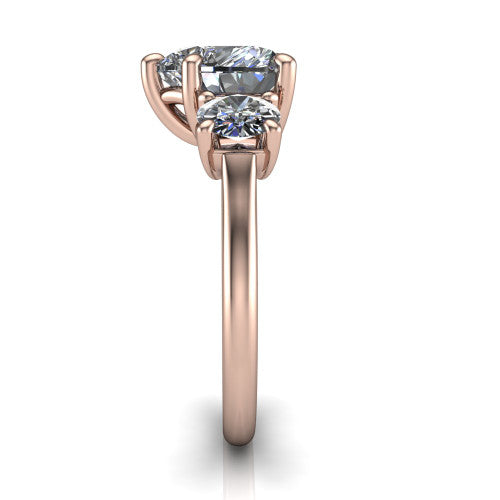 Emma heart three stone engagement ring in 14K Rose Gold, side profile showing the round side stone and the smooth tapered polished band