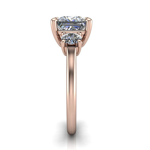 Emma princess three stone engagement ring in 14K Rose Gold, side profile showing the round side stone and the smooth tapered polished band