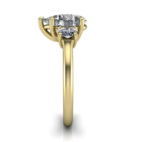 Emma pear three stone engagement ring in 18K Yellow Gold, side profile showing the round side stone and the smooth tapered polished band