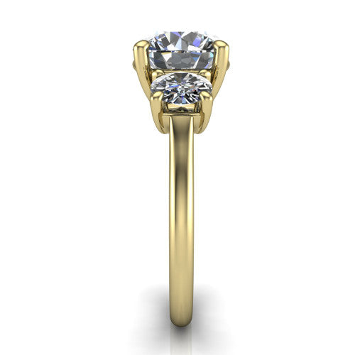 Emma round three stone engagement ring in 18K Yellow Gold, side profile showing the round side stone and the smooth tapered polished band