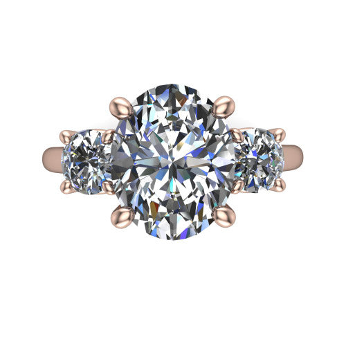 Emma oval three stone engagement ring in 18K Rose Gold, top-down view showing the center diamond flanked by two round side stones in a classic three stone setting