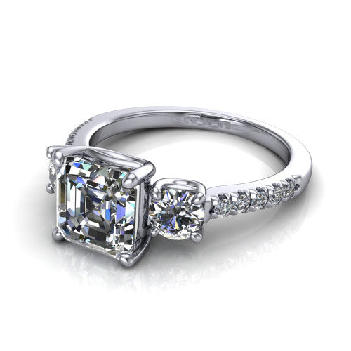 Celeste asscher three stone engagement ring in 18K White Gold, three-quarter perspective showing the center diamond between two round side stones above a pav&eacute; shank
