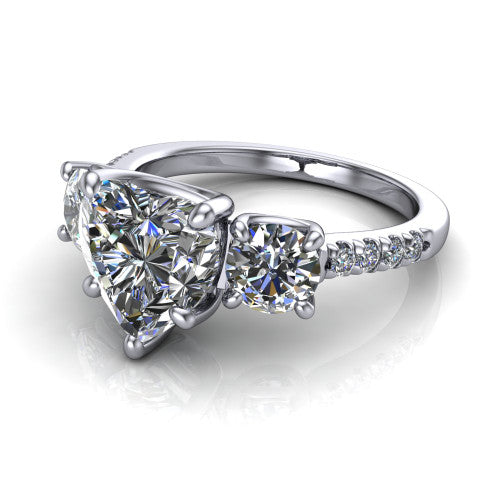 Celeste heart three stone engagement ring in 14K White Gold, three-quarter perspective showing the center diamond between two round side stones above a pav&eacute; shank