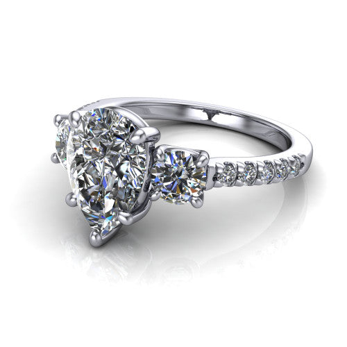 Celeste pear three stone engagement ring in Platinum, three-quarter perspective showing the center diamond between two round side stones above a pav&eacute; shank