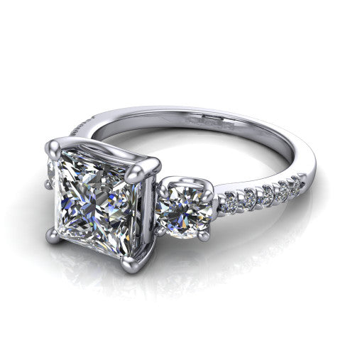 Celeste princess three stone engagement ring in Platinum, three-quarter perspective showing the center diamond between two round side stones above a pav&eacute; shank