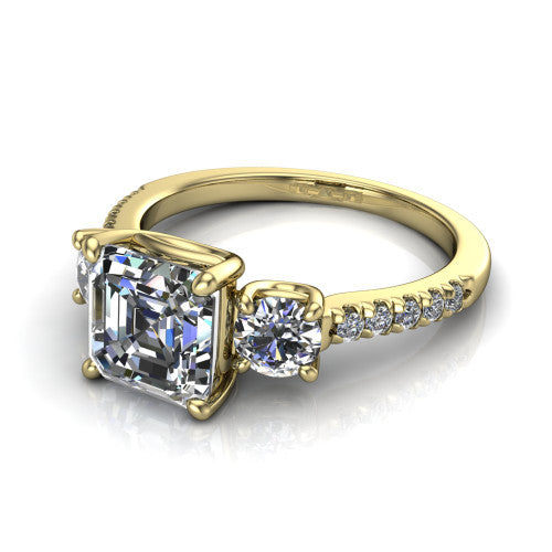 Celeste asscher three stone engagement ring in 18K Yellow Gold, three-quarter perspective showing the center diamond between two round side stones above a pav&eacute; shank