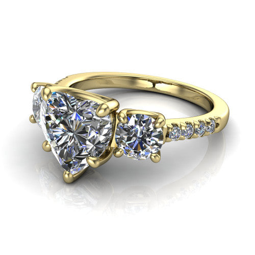 Celeste heart three stone engagement ring in 18K Yellow Gold, three-quarter perspective showing the center diamond between two round side stones above a pav&eacute; shank